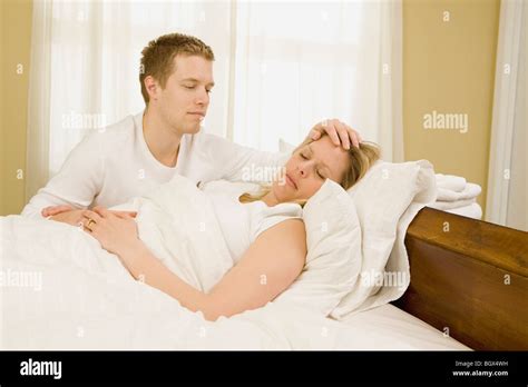 Loving Husband Caring For Sick Wife In Bed Stock Photo Royalty Free