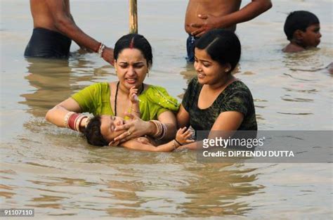 river bathing indian women photos and premium high res pictures getty images