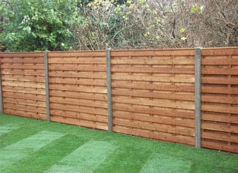 A Wooden Fence With Grass In The Yard