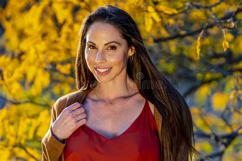 A Lovely Brunette Model Poses Outdoor While Enjoying The Fall Weather