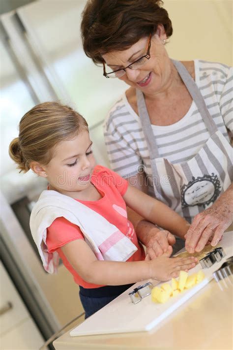 Grandmother Teaching Her Granddaughter How To Bake Cookies Stock Image Image Of Helping