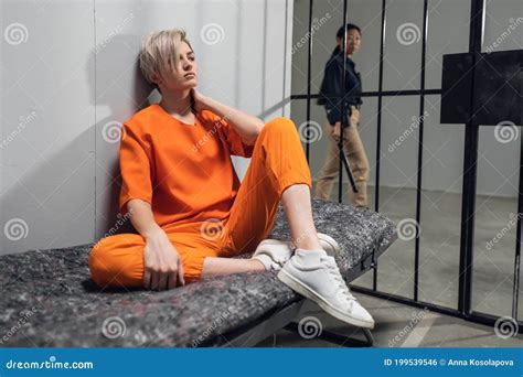 Blonde Inmate In An Asian Women`s General Security Prison Is Led Out Of