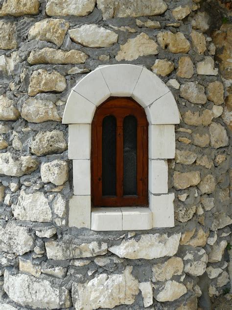 Small Arch Window On A Stone Wall Texture In Category Windows Doors