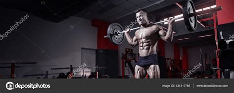 Muscular Bodybuilder Guy Doing Exercises With Dumbbell Stock Photo