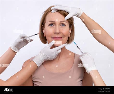 injection medicine for skin rejuvenation cosmetologists making anti aging shots into senior