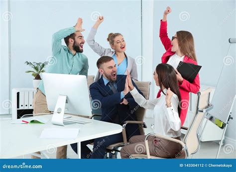 Group Of Office Employees Celebrating Victory Stock Photo Image Of