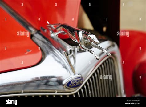 Vintage Ford Model 48 roadster greyhound hood ornament close up on the