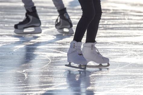 Feet Of Different People Skating On The Ice Rink Stock Photo Image Of