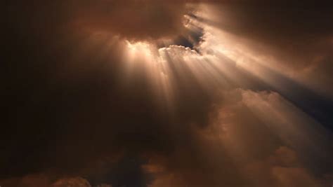 Light Beams Of Sun Stream From Roiling Clouds In The Sky Loop Stock
