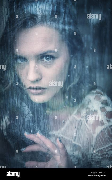 Girl Looking Through Rainy Window Stock Photo Alamy