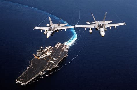 Two Fa 18c Hornet Aircraft Of Strike Fighter Squadron 74 Fly Above The Forrestal Class