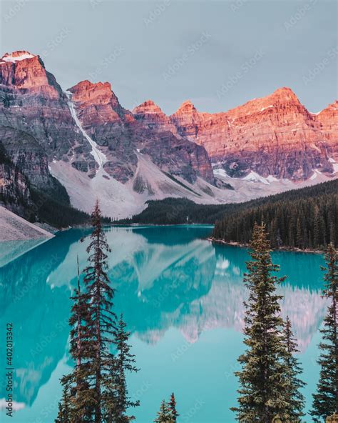 Turquoise Waters Of Moraine Lake As The Sunrise Lights Up The Mountain