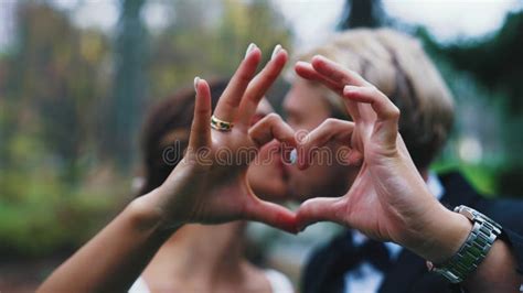 Romantic Old Couple Making Heart Sign With Hands Looking At Each Other