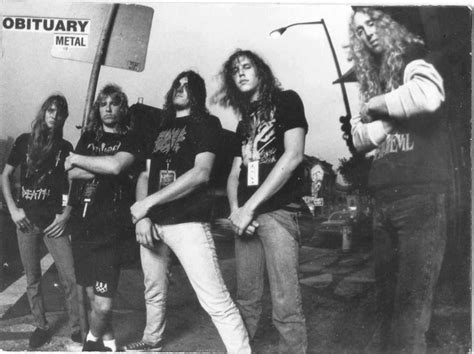 An Old Black And White Photo Of Five Men Standing In Front Of A Metal Sign