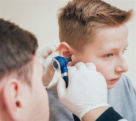 Doctor Examines Boy Ear With Otoscope Medical Equipment Stock Image
