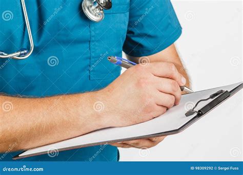 Male Doctor With Stethoscope Writing On Clipboard Message Or Boa Stock