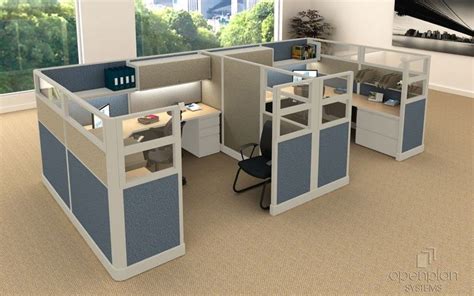 An Office Cubicle With Two Desks And One Chair In Front Of A Window