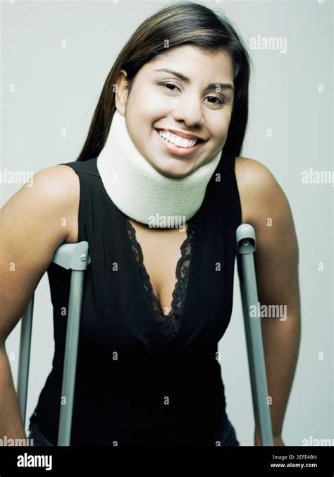 Portrait Of A Young Woman Wearing A Neck Brace And Standing With