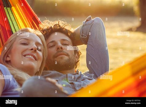 Couple Relaxing Together In Hammock Portrait Stock Photo Alamy