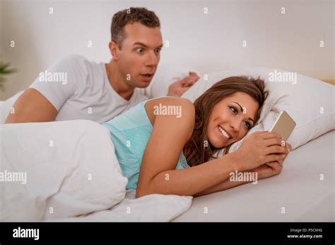 Wife Cheating Her Husband Using Mobile Phone In Bed Husband Is