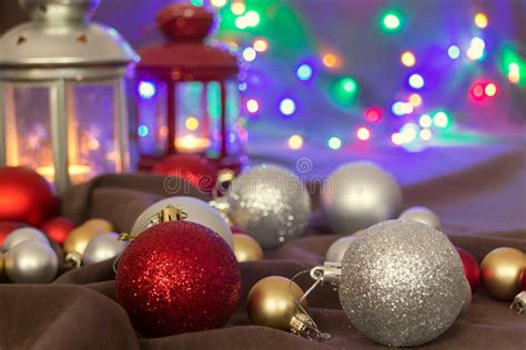 Christmas Balls And Lanterns On Brown Background And Fairy Lights Stock