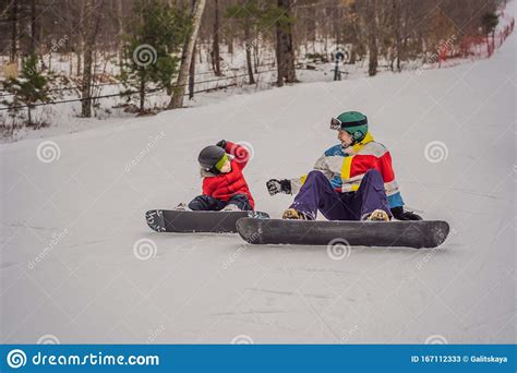 Snowboard Instructor Teaches A Boy To Snowboarding Activities For