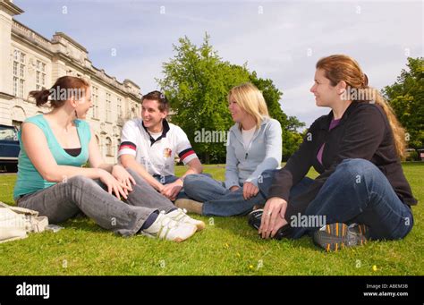 Cardiff University Students Relaxing And Chatting On The Lawn In Summer