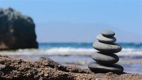 Stones Pyramid On The Beach Ocean In The Background Stock Footage