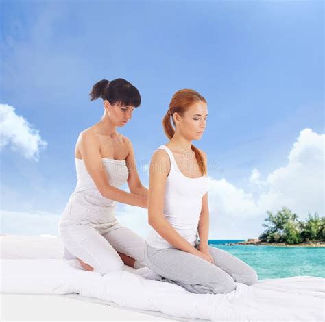 Young Woman Getting Traditional Thai Stretching Massage By Therapist Over Marine Landscape Stock
