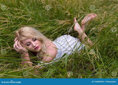 Pretty Blonde Woman Lying In High Grasses Stock Image Image Of