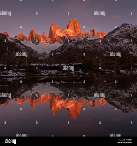The Mountain Range With Cerro Fitz Roy At Sunrise Reflected In Lake