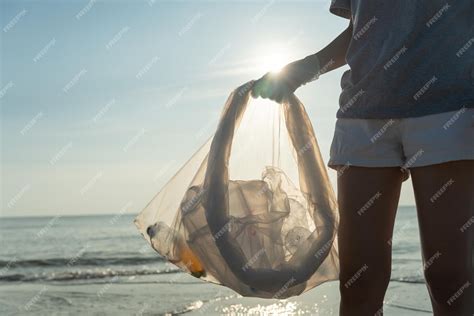 Premium Photo Save Water Volunteer Pick Up Trash Garbage At The Beach