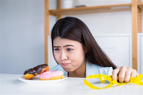 Premium Photo Asian Women Have A Craving For Delicious Donuts