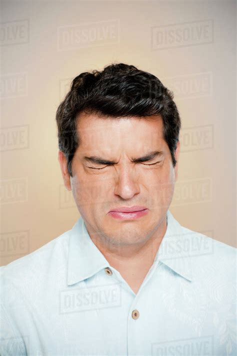 Portrait Of Man Frowning With Closed Eyes Stock Photo Dissolve