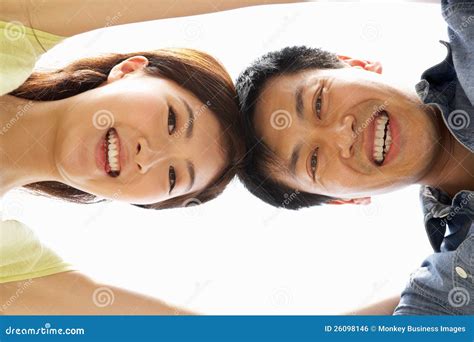 Young Chinese Couple Looking Down Into Camera Royalty Free Stock Image