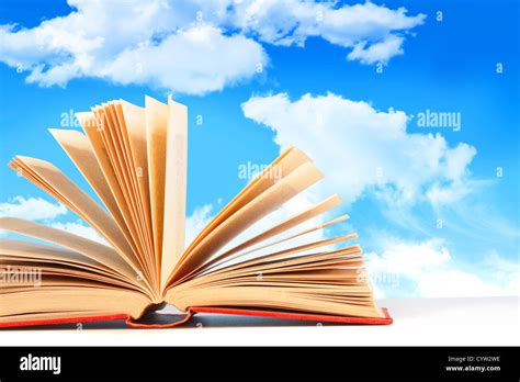 Open Book On White Surface Against A Blue Sky Stock Photo Alamy