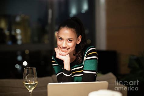 Portrait Woman Drinking White Wine At Laptop Photograph By Caia Image