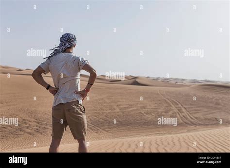 Young Male Tourist Standing On Sand Dunes Desert Dubai Hi Res Stock