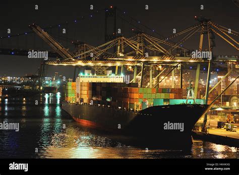 Cargo Ship In Port With Containers At Night Stock Photo Alamy