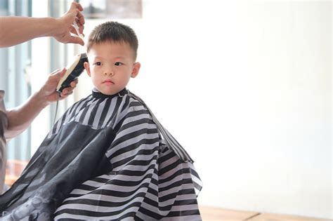 Cute Little Asian Boy Child Getting A Haircut At The Hairdressers