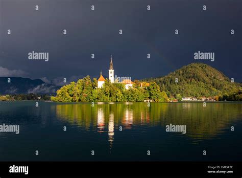 Dramatic Storm Clouds And A Rainbow On Lake Bled In Slovenia Europe Eu
