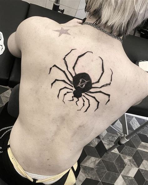 A Man With A Spider Tattoo On His Back