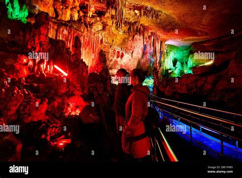 Tourist Couple In Underground Cave Sataplia With Colorful Illumination