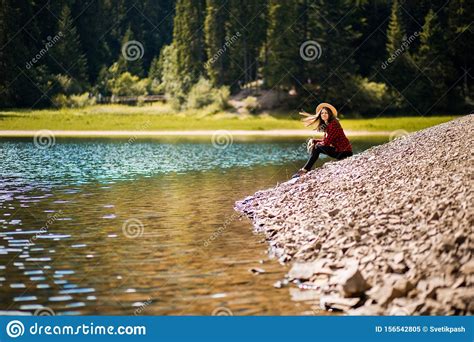 Tourist Woman In Straw Hat Rest Near Turquoise Blue Lake And Scenic