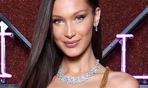 Bella Hadid Commands Attention In A Plunging Black Top And Pinstripe Blazer While Going Braless