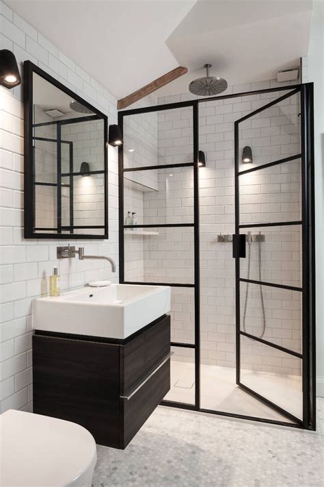A Bathroom With A Toilet Sink And Walk In Shower Next To A White Tiled