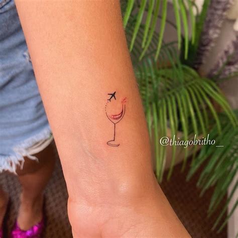 Fine Line Wine Glass And Airplane Tattoo On The Wrist