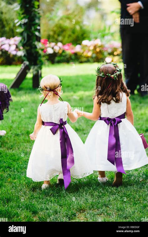 Flower Girls Walking Down Aisle At Wedding Stock Photo Alamy