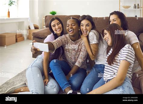 Company Of Multiracial Female Friends Have Fun And Take Selfies During Friendly Meetings At Home