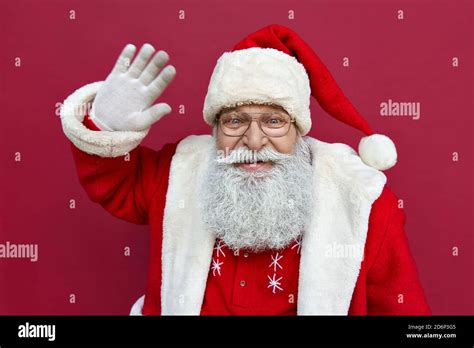 Happy Santa Claus Wearing Costume Waving Hand Looking At Camera Stock